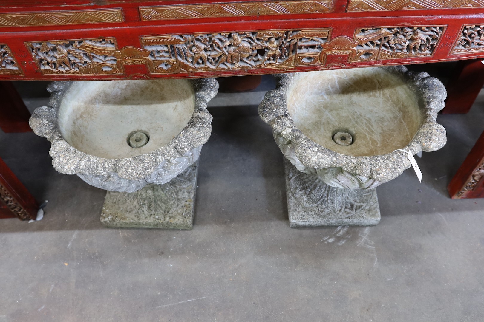 A pair of circular reconstituted stone garden planters moulded with acanthus leaves, diameter 50cm, height 43cm